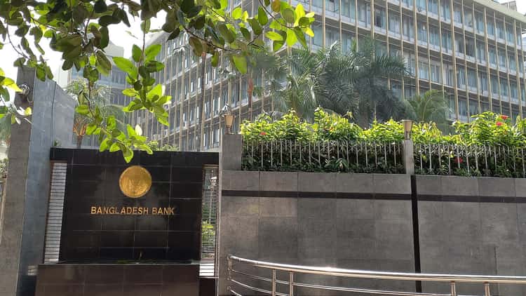 The entrance sign of Bangladesh Bank in Dhaka, with the office building behind it